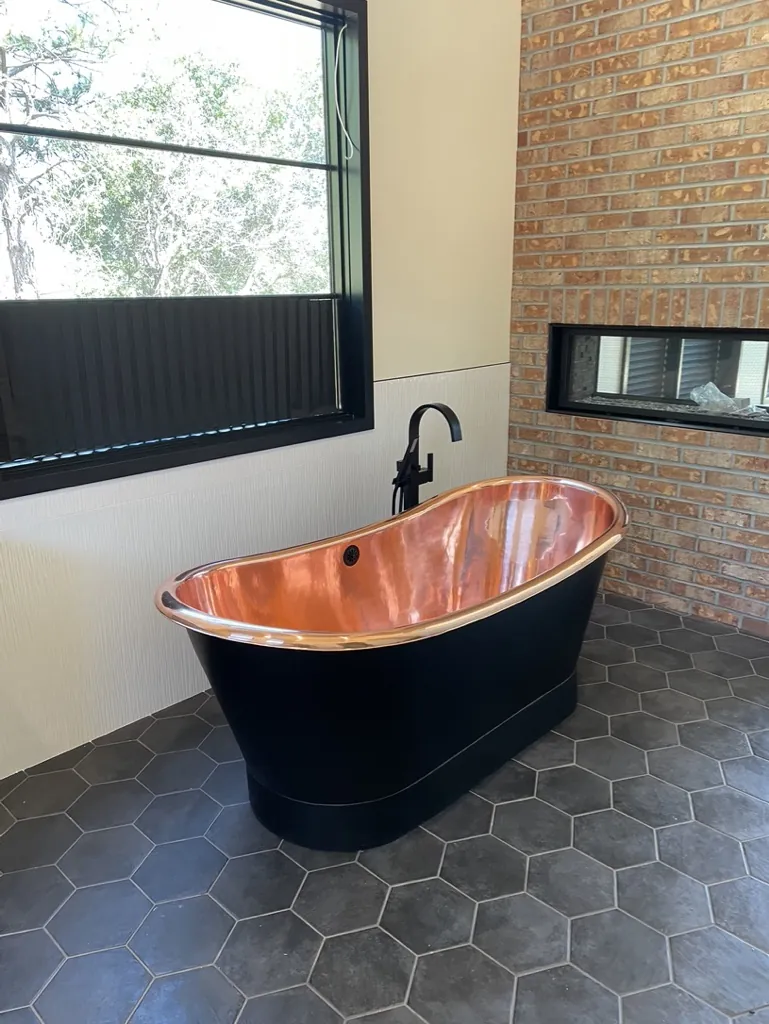 Custom copper bathtub installation by J. Hart Plumbing