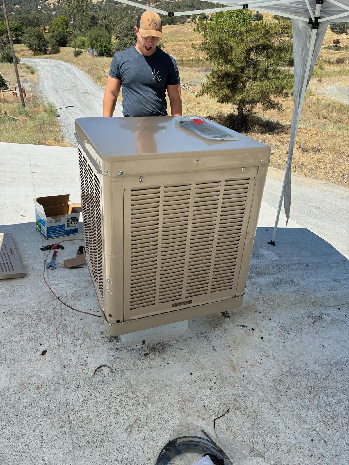 J. Hart technician installing an evaporative cooler near Sonora, CA