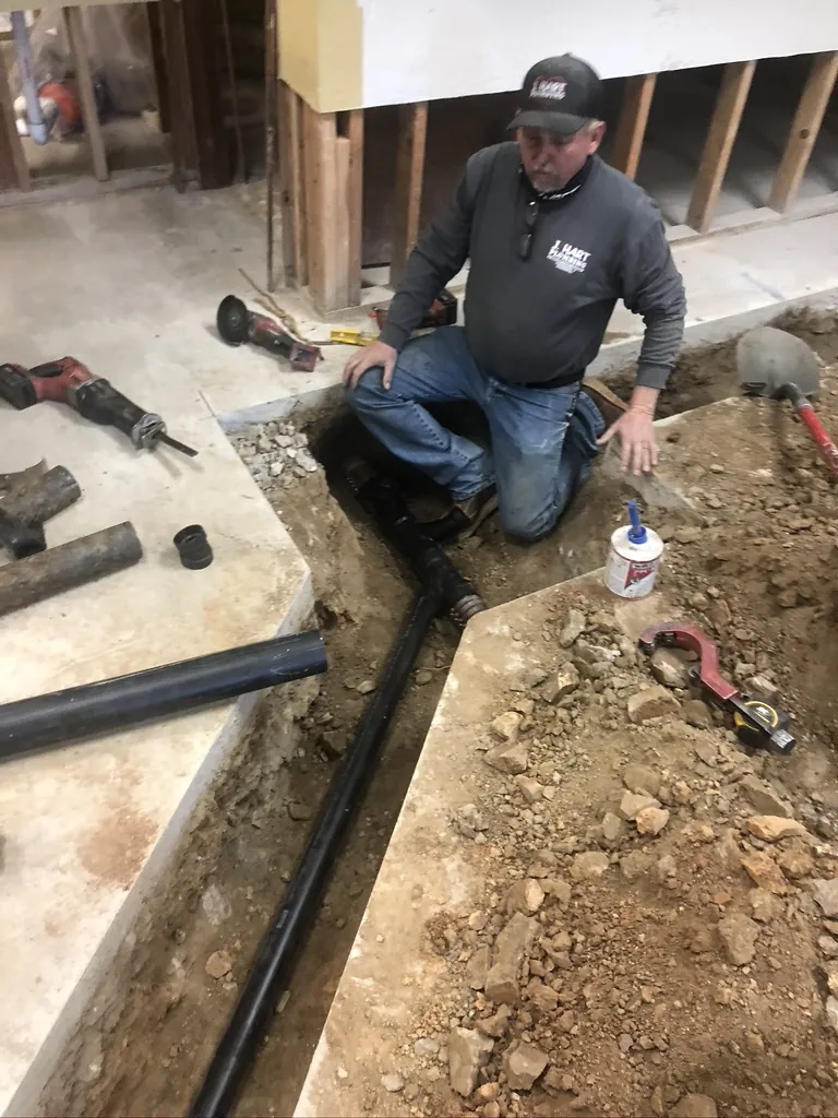 J. Hart plumber working on slab pipe installation