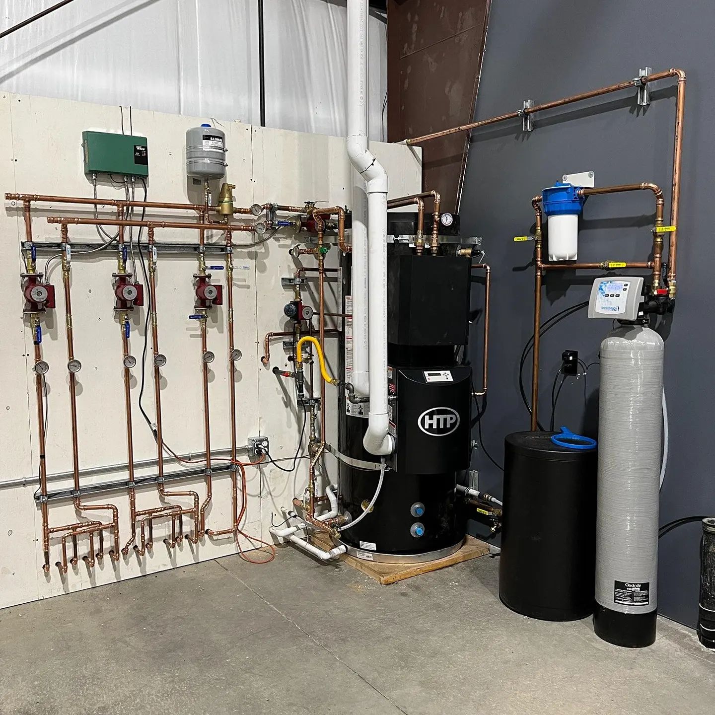 Water treatment system with HTP boiler, water softener, and copper piping installed by J. Hart Plumbing